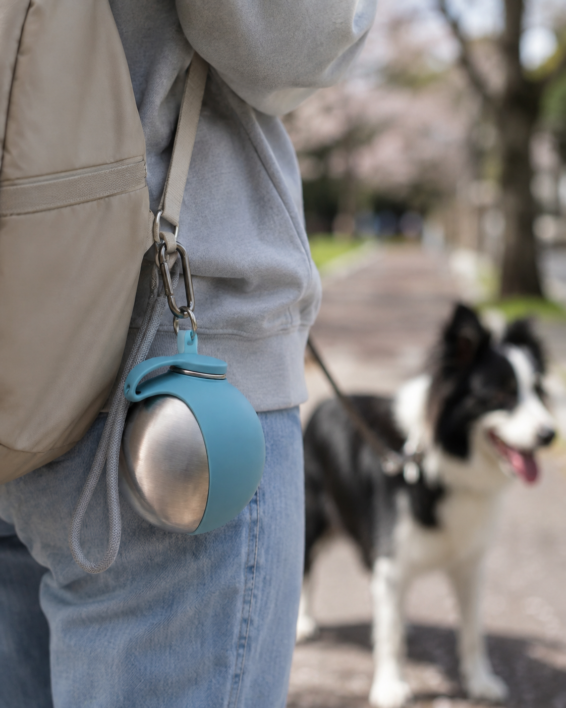 Portable dog water bottle clipped to a bag